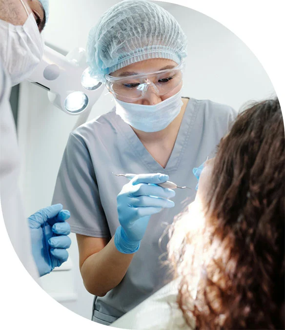 a dentist checking her client's teeth